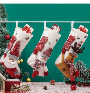 Detailed view of three festive Christmas stockings with Santa, snowman and reindeer plush characters
