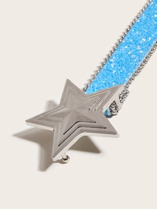 Detailed macro view of a star-shaped silver buckle and blue glitter strap belt