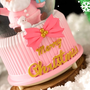 Pink and gold Christmas music box water ball with Merry Christmas text and festive decor