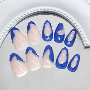 Blue and pink almond-shaped press-on nails with 3D water ripple effect on a mirror