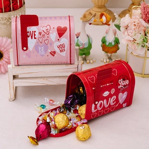 Red and pink mailbox shaped tin boxes for Valentine gifts with candy and floral decor