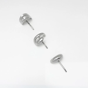 Detailed view of three minimalist geometric silver stud earrings in polished metal