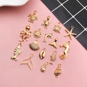 Detailed view of golden marine animal charms including sea turtles and starfishes