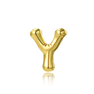 Macro view of a 3D letter Y pendant in 18K gold plated copper with metallic luster