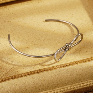Elegant silver bow-knot open cuff bracelet made of polished minimalist stainless steel