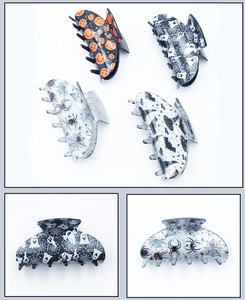 Set of four glittery Halloween hair claws featuring pumpkin, ghost, and spider motifs