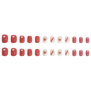 Short strawberry and heart pattern red press-on nails with 24 pieces on white background