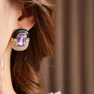 Vintage gold square earrings with purple stones and black enamel worn by a model