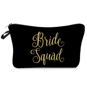 Close-up of black canvas makeup bag with gold Bride Squad lettering and zipper handle