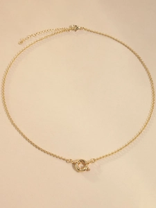 Detailed close-up of 18K gold-plated necklace chain and round spring clasp fastener