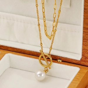 Double-layered gold necklace with paperclip chain, OT toggle clasp, and white pearl pendant