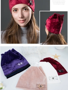 Close-up of velvet winter beanie featuring a sparkling rhinestone bow detail and various colors