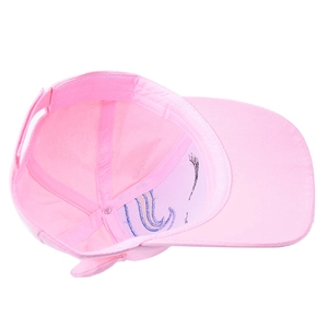 Detail of pink cotton unicorn baseball cap showing interior stitching and adjustable strap