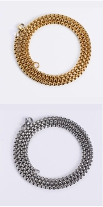 Detailed close-up of gold and silver box chains with secure lobster clasps in steel