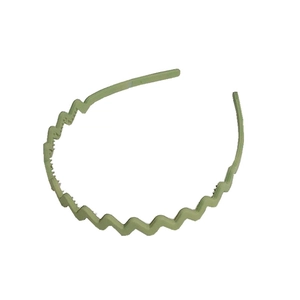 Green wavy plastic headband with anti-slip teeth design on a clean white background