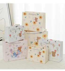 Detail of colorful cartoon gift bags with floral patterns and sturdy rope handles