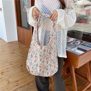 Detailed close-up of a large floral canvas tote bag featuring a vibrant flower pattern