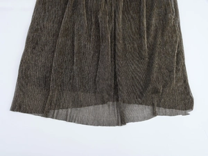 Detailed close-up of dark grey pleated metallic fabric with fine shimmer texture