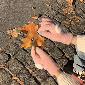 Warm pink fleece gloves with white faux fur pom-poms and touch screen design for winter