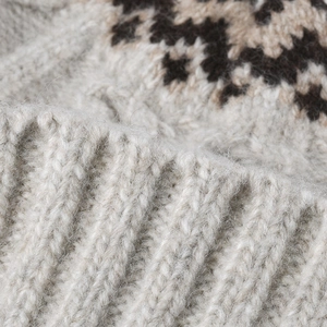 Close-up of Fair Isle knit beanie showing thick wool blend texture and ribbed cuff
