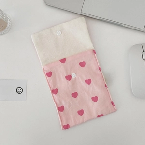 Detail of pink canvas tote bag showing the snap button closure and red heart patterns