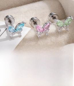 Close-up of zirconia butterfly helix studs in blue, pink, and green colors