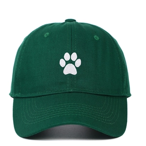 Close-up of a dark green cotton baseball cap featuring white paw print embroidery detail