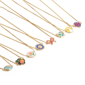Golden chain necklaces with colorful enamel geometric pendants on white background