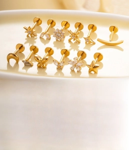 Macro shot of titanium alloy flat back studs with moon, star, and flower zircon designs