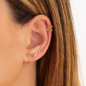Minimalist S925 silver needle gold moon and star earring set worn on model's ear