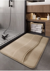 Close-up of beige memory foam bathroom mat with soft curved line texture and plush feel