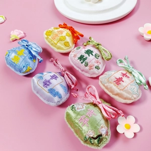 Detailed view of six colorful embroidered silk lucky pouches with traditional Chinese motifs