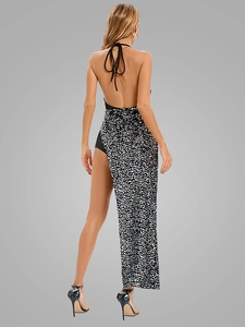 Detail of sequin backless evening gown featuring a halter neck and asymmetrical long skirt