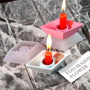 Detailed view of trapezoid candle holder silicone mold with finished plaster samples