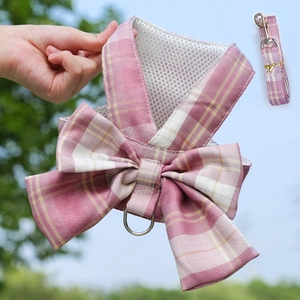 Close-up of pink plaid pet harness with breathable mesh lining and a large decorative bow