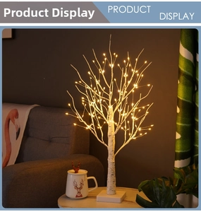 Cozy home setting featuring a decorative LED birch tree light on a marble tabletop