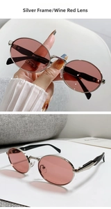 Detail of retro oval sunglasses featuring silver metal frames and wine red lenses