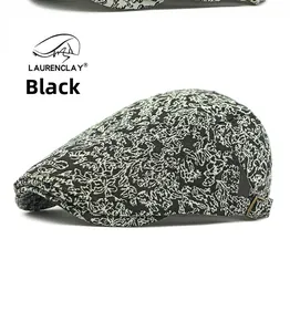 Detail of foliage jacquard pattern and bronze adjustable metal buckle on black flat cap