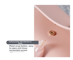 Detailed close-up of pink leather wallet featuring a durable golden metal snap button