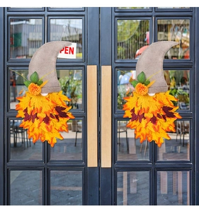 Detailed close-up of autumn gnome door hangers with burlap hats and colorful maple leaves