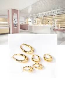 Detailed set of three graduated gold-tone chunky teardrop hoop earrings with mirror polish