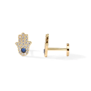 Detailed view of golden Hamsa Hand earrings with blue and clear zircon stones