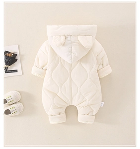 Detail of cream quilted baby romper with ear hood and ribbed cuffs for winter warmth