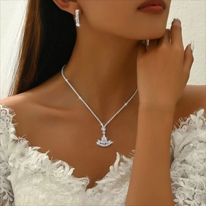 Close-up of bridal jewelry set with sparkling rhinestone fringe necklace and earrings