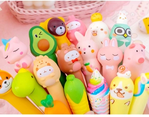 Assorted cartoon squishy gel pens with unicorn and animal shapes in a pink basket