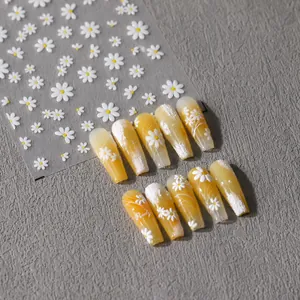 Detail view of 5D embossed white daisy nail stickers and finished floral nail art
