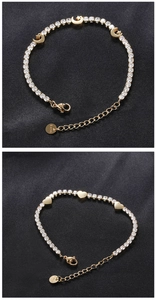 Detail of gold-plated celestial and heart tennis bracelets on black satin backdrop