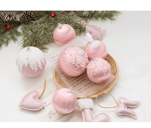 Pink Christmas ornaments collection with plush balls and stars on festive pine branches
