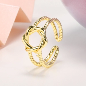Macro shot of 18k gold plated twisted knot open ring with double layer texture