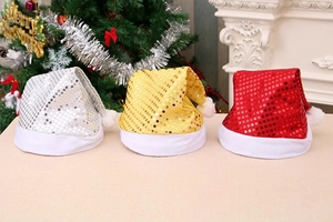 Close-up of sparkling sequin Christmas hats in silver, gold, and red with plush white trim